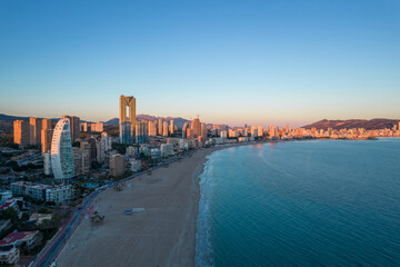 Benidorm Playa de Poniente beach at sunset with tall buildings. Tourist city with skyscrapers