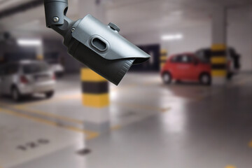 CCTV camera in underground parking garage. Copy space.