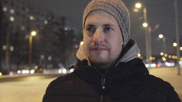 Closeup portrait of young caucasian man having cold on winter night, outside