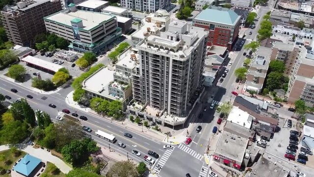 Drone orbiting apartment building in downtown Burlington in summer.