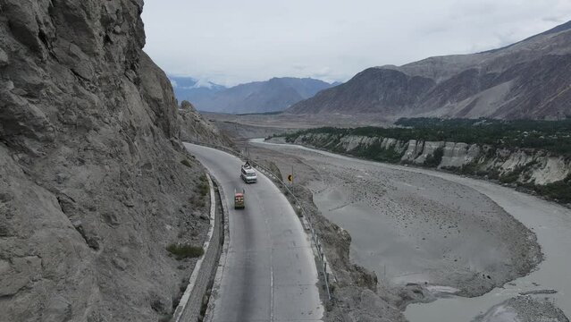 Dramatic Landscapes of Pakistan. Aerial View of Road Traffic in Babusar Mountain Pass by Kunar River, Drone Shot