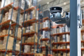 CCTV Camera Operating inside warehouse or factory. Copy space.
