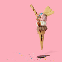 funny creative concept of flying wafer cone with ice cream covered, strewed sprinkles decorated...