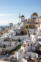  Whitewashed houses and windmills in Oia on Santorini island, Cyclades, Greece