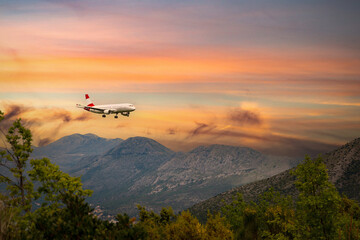 Obraz na płótnie Canvas Airplane landing in Dubrovnik airport (Cavtat) on a sunset time.