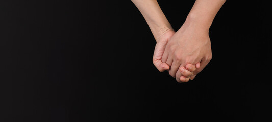 Holding hands gesture on black background