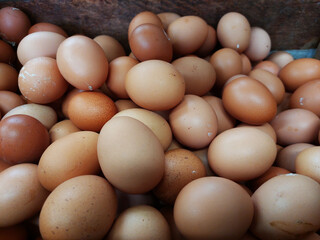 Raw brown chicken eggs pile as background flat lay view