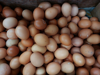 Raw brown chicken eggs pile as background flat lay view