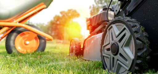 self-propelled lawn mower on green grass