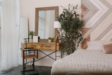 fragment modern wooden bedroom with bed, mirror, wardrobe and chair
