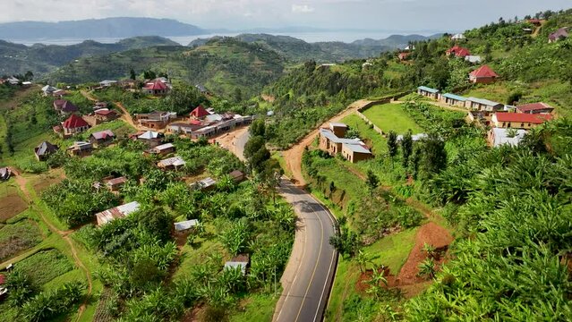 High drone shot of mountain side two lane road in Rwanda.