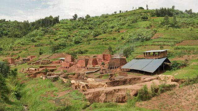 Wide shot of brick making operation in rural Rwanda.