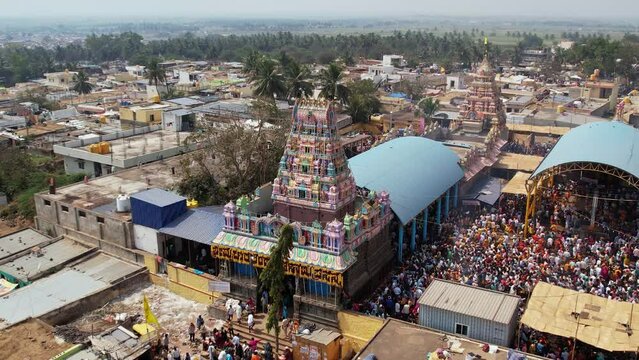 A huge crowd of people gathered at a temple during a religious festival