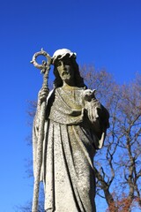 A statue of an older Jesus Christ holding a lamb.