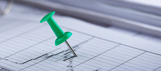 Marking financial chart by pins.Share listing and checking financial chart. Concept of banking, financial report and financial audit.