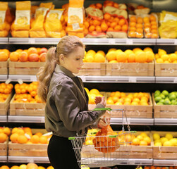 Woman buying fruits and vegetables at the market