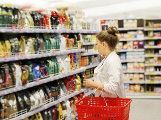 supermarket shopping, face mask,Woman choosing a dairy products at supermarket.