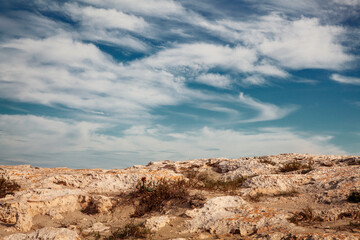 cloudy blue sky above a rocks as background - 571212655