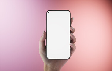 CU 20s Caucasian female holding a phone in a left hand. Pink pastel background