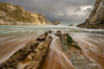 Tidal water through the rocks, \Man O War Cove, Dorset, UK