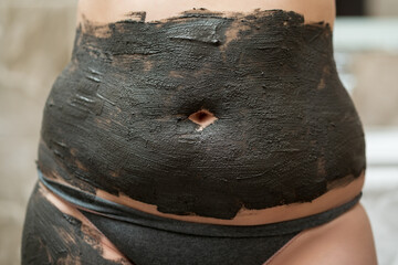 Mud spa procedure, woman applying cosmetic clay body mask, anti cellulite skincare concept