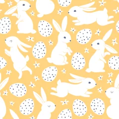 Vintage seamless pattern with hares rabbits and Easter eggs in peas. Small cute daisy flowers. Cartoon animals in hand-drawn doodle style. Monochrome white characters on a yellow background. Vector. © Світлана Харчук