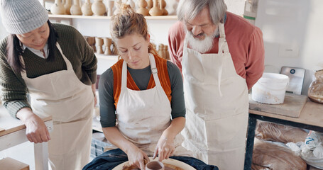 Pottery, group and teacher mold clay in studio or workshop learning with instructor woman, coach or trainer. Lesson, art and people practice hobby, arts or crafting handmade ceramic mug, cup or bowl
