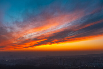 Colourful landscape of beautiful sunset above the night city.