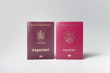 Close-up of Moldavian and Romanian passports isolated on white background.