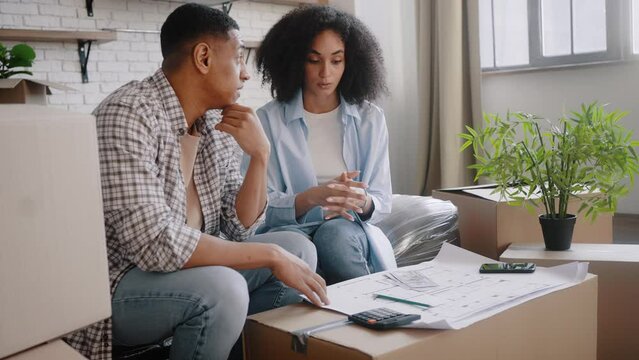 Multiethnic young woman counts cash, feels sad about not having enough money to renovate new house