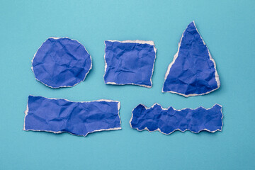 Torn blue paper for message on white light blue paper background.