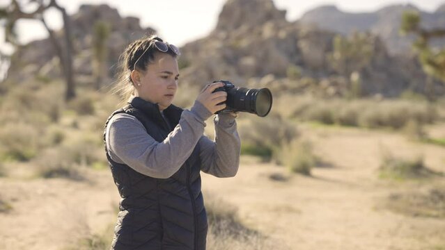 Girl Photographing Joshua Tree National Park desert California with a Sony A1 camera - shooting a video