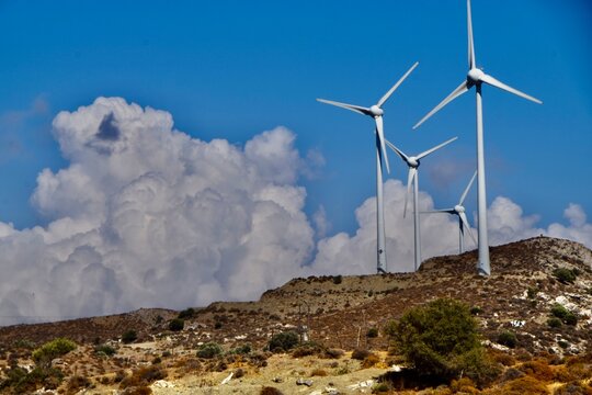 wind turbines against cloudy sky