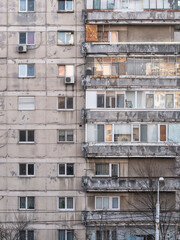 Worn out apartment building from the communist era against blue sky in Bucharest Romania. Ugly traditional communist housing ensemble