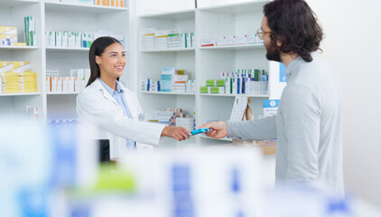 Patient buying medicine from pharmacist at the pharmacy store. Customer receives prescription...