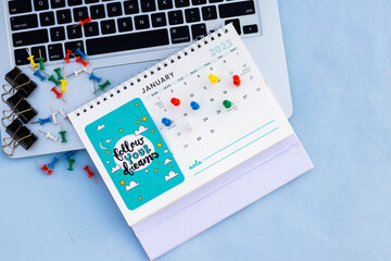 Colour push pins on calendar 2023 event Planner calendar, clock to set timetable organize schedule, planning for business meeting or travel planning concept