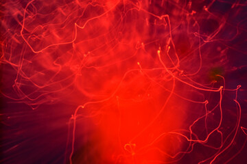 Red abstract background of many light lines