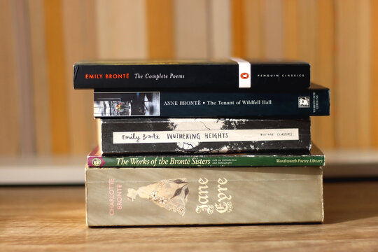 Split, Croatia - January 15, 2023: Stack of classic English books by Bront&euml; sisters. Bookshelf in the background. Selective focus.