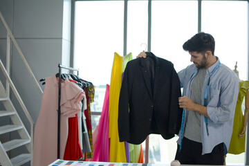 Young designer with his suit, Fashion design.