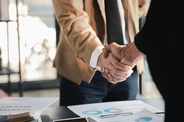 Business investor group holding hands, Two businessmen are agreeing on business together and shaking hands after a successful negotiation. Handshaking is a Western greeting or congratulation.