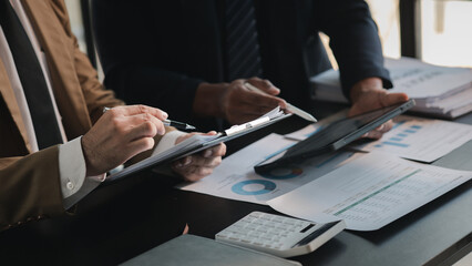 The sales department is having a monthly summary meeting to bring it to the department manager, they are verifying the correctness of the documents that are prepared before bringing in to the manager