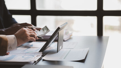 Naklejka premium The sales department is having a monthly summary meeting to bring it to the department manager, they are verifying the correctness of the documents that are prepared before bringing in to the manager