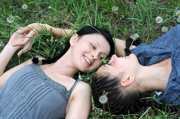  two young beautiful women in the silent communication at the spring meadow
