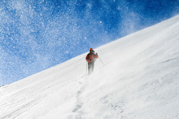 Snow hiker walking on snow during a snowstorm,s elective focus