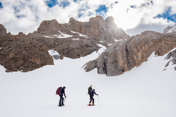 Snow hiker walking in a snowy hillside in a sunny day