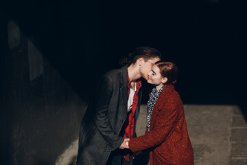 Caucasian young couple walking in the street at Valentines day.