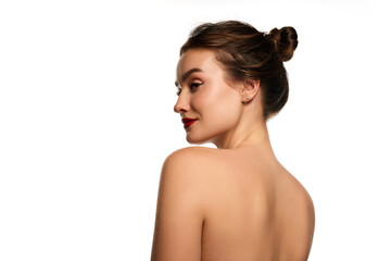 Side view portrait. Naked shoulders. One beautiful brunette girl posing against white studio background. Concept of natural beauty, youth, health, wellness, femininity, make-up