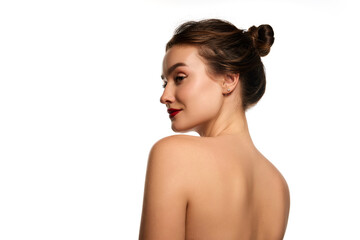 Obraz premium Side view portrait. Naked shoulders. One beautiful brunette girl posing against white studio background. Concept of natural beauty, youth, health, wellness, femininity, make-up