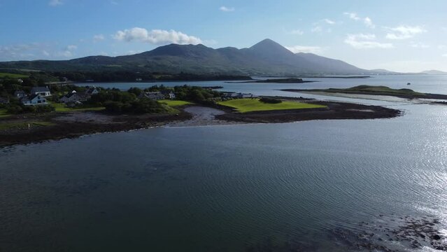 Breathtaking rising aerial over water of Croagh Patrick mountain in Ireland
