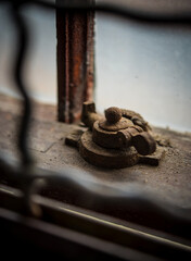 An old, rusty lock and latch in an abandoned building